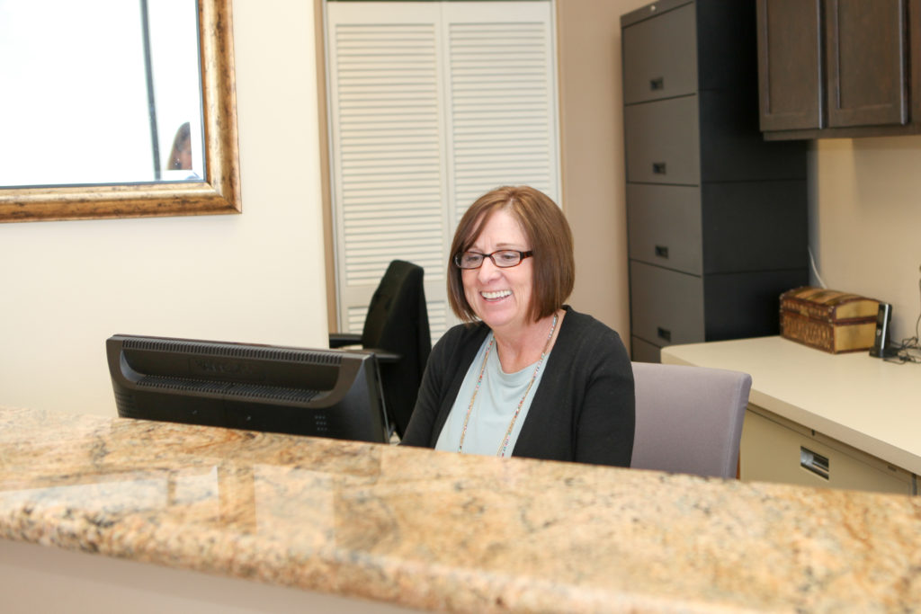 receptionist for Ridgeview Dental in Centennial, CO smiling